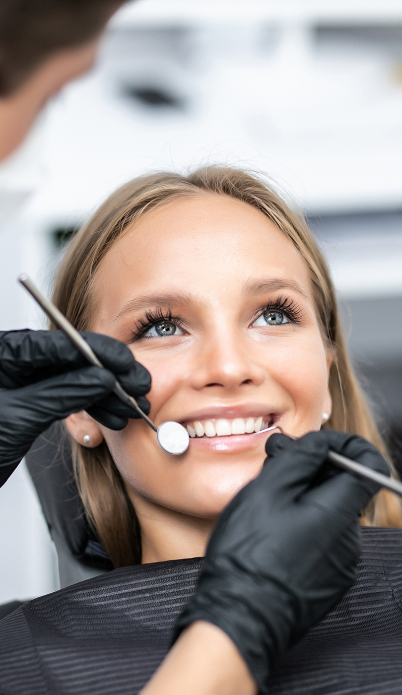 The image shows a modern dental or medical office interior with a dental chair, equipment, and a clean, professional environment.