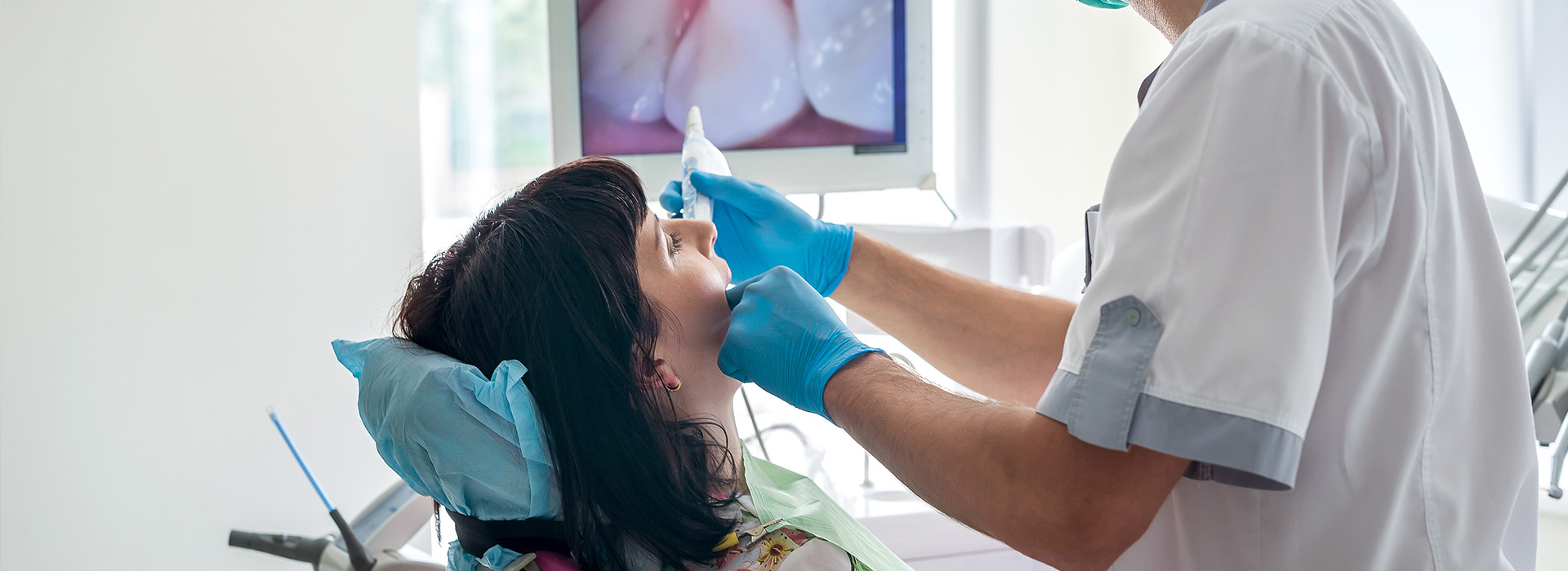 A dental professional attends to a patient s mouth with dental instruments during a routine checkup.